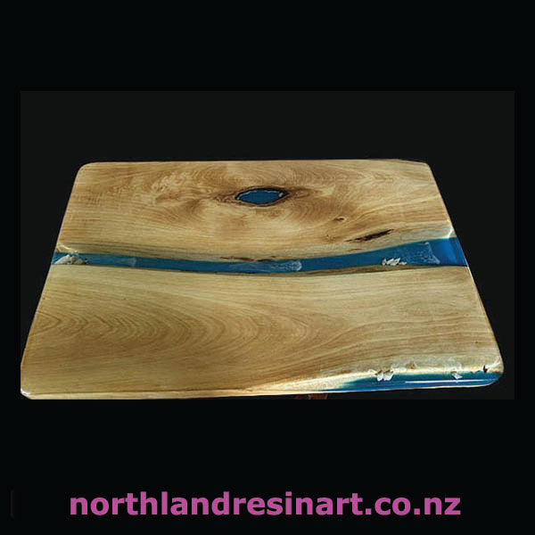 Wooden surface with blue resin inlay on a black background, featuring 'northlandresinart.co.nz'.