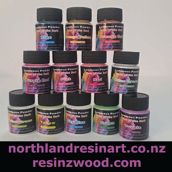 Assorted bottles of luminous powder in various colors with a white background.