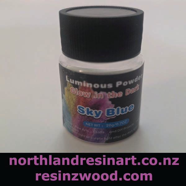 Jar of luminous powder labeled 'Glow in the Dark Sky Blue' with a black lid on a white background.