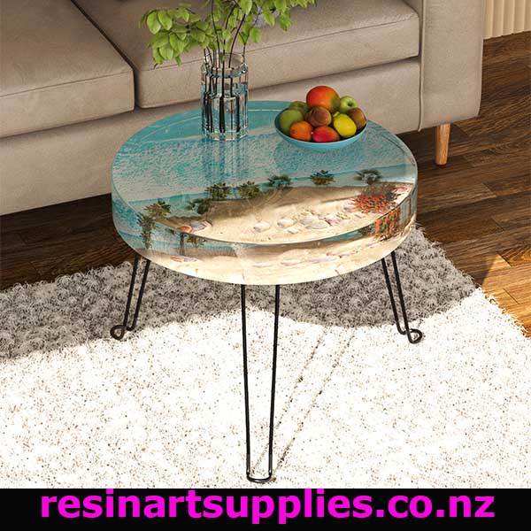 Round glass coffee table with metal legs in a living room setting, featuring a fish tank design.