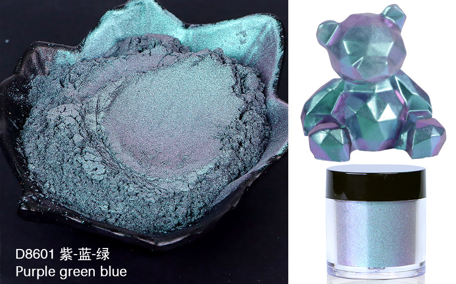 Purple green blue powder in a container with a colorful bear figurine and jar on a white background
