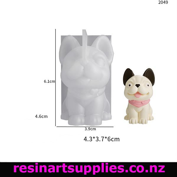 Silicone mold of a dog with dimensions and a small dog figurine on a white background.