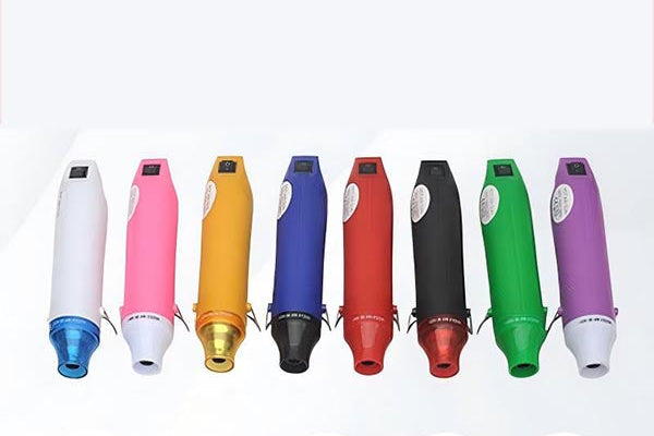 Eight handheld beauty devices shown in different colors on a white background, with four plug icons below. The devices include white, pink, yellow, blue, red, black, green, and purple models, each with a small digital display and a different connector plug.