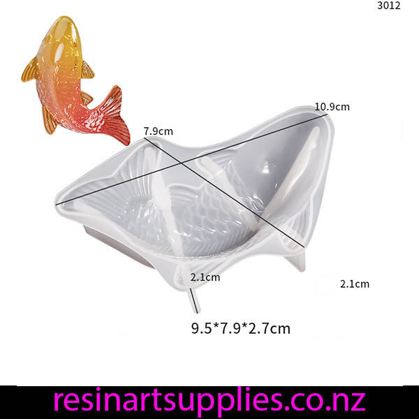 Clear silicone mold shaped like a fish with dimensions and a small orange fish figurine on a white background.