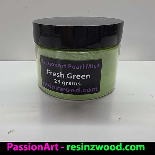 Jar of green powder with a black lid on a white surface, featuring 'PassionArt' branding.