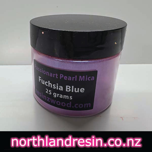 Jar of Fuchsia Blue Passionart Pearl Mica on a white surface with a light green background