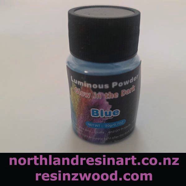 Bottle of blue luminous powder with a black lid on a white background, featuring branding text.