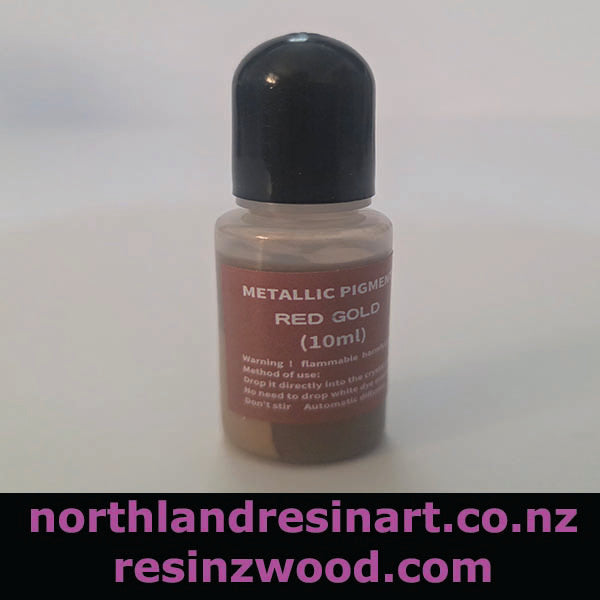 Bottle of metallic pigment with red gold color on a white background, featuring branding text.