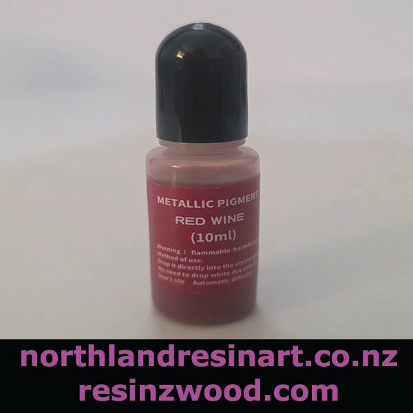 Bottle of metallic pigments with red wine color on a white background, featuring branding text.