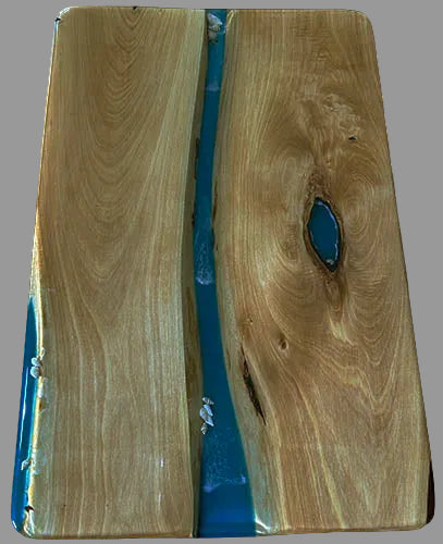 Wooden board with blue resin inlay on a white background