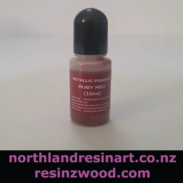 Bottle of metallic pigment in ruby red color on a white background with branding text.