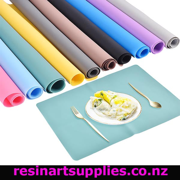 Set of colorful placemats and a plate with food on a white background, featuring the brand 'resinartsupplies.co.nz'.
