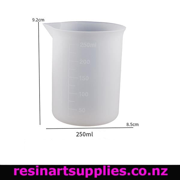 White measuring beaker with measurement markings on a white background, featuring dimensions and a brand logo.