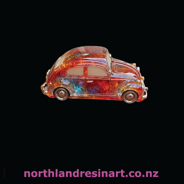 Colorful resin car sculpture on a black background with 'northlandresinart.co.nz' text.