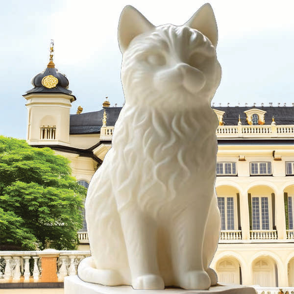 White stone sculpture of a Cat in front of a grand building with a blue sky.
