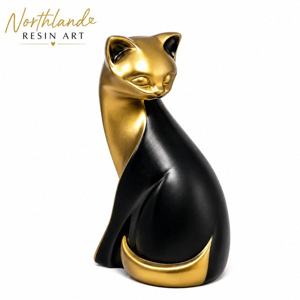 Gold and black cat resin art sculpture made using a cat silicone mould on a white background
