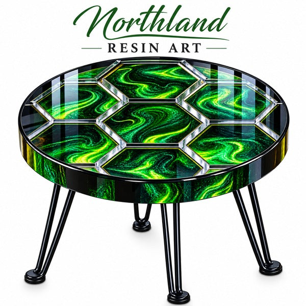 A round resin art table with a glossy black and vibrant green swirled pattern on the tabletop, supported by black metal hairpin legs. The brand logo 'Northland Resin Art' is displayed at the top of the image against a clean white background.