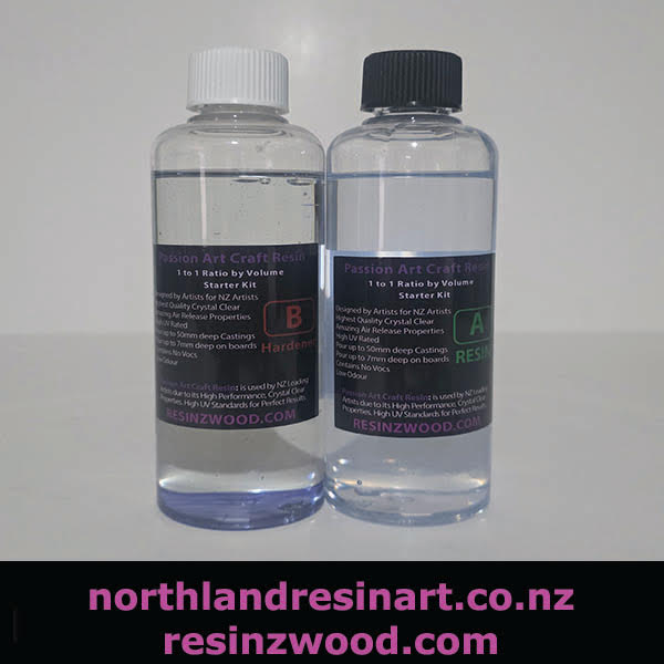 Two clear resin bottles with labels on a light gray background, featuring 'northlandresinart.co.nz' and 'resinzwood.com'.